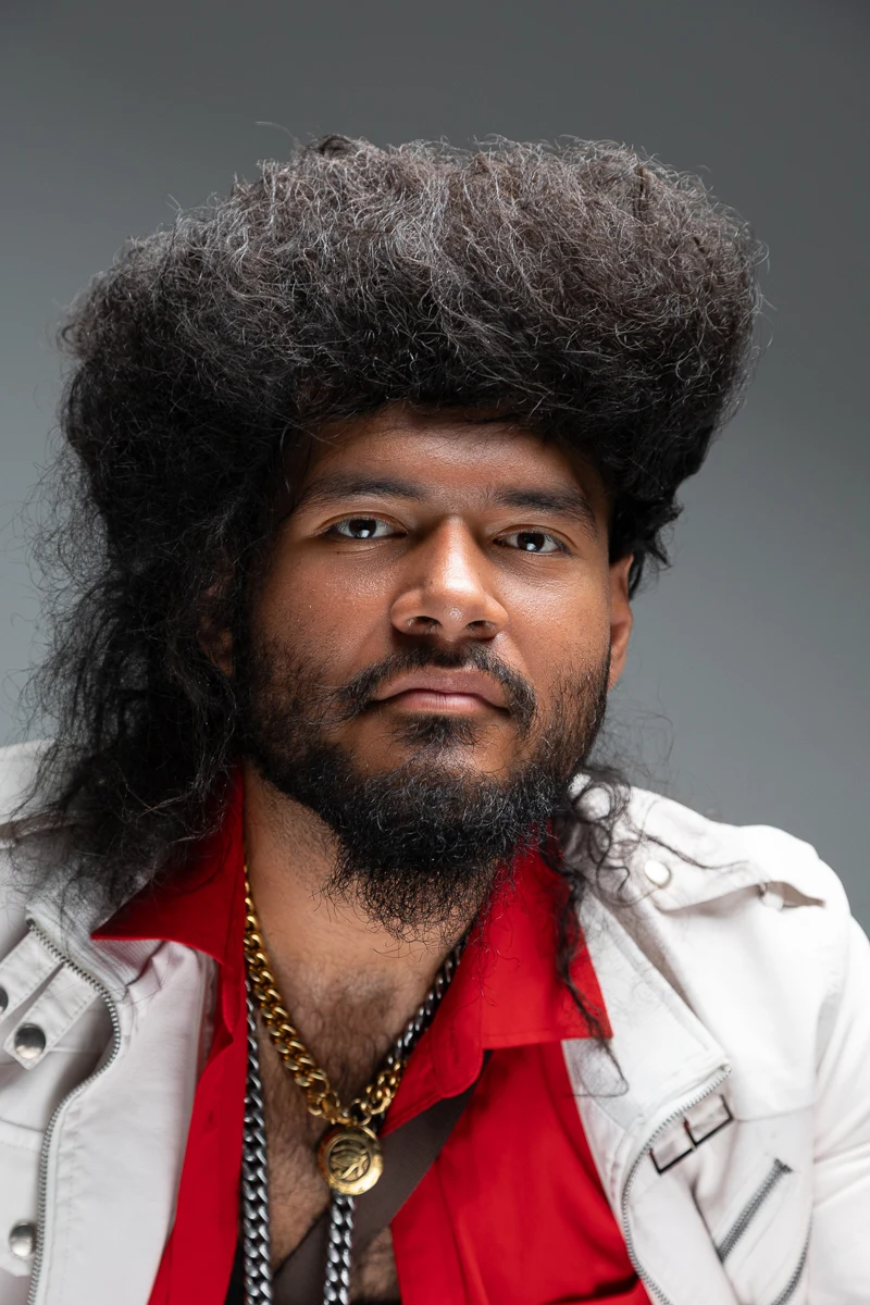 Expressive close-up portrait with a white jacket and red shirt.